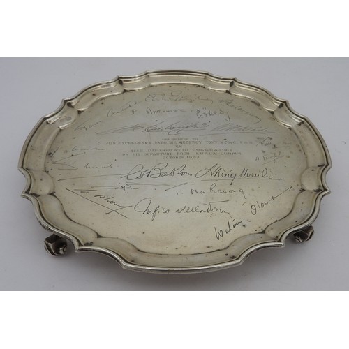 838 - A SILVER PRESENTATION SALVER, circular form with scroll edge, inscribed with dedication and signatur... 