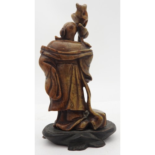 321 - A SMALL SOAPSTONE FIGURE OF SHULAO, 20TH CENTURY, modelled in robed attire holding a tree root staff... 