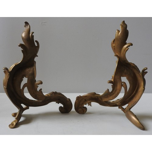 153 - A PAIR OF FRENCH GILT BRASS CHENETS, 19TH CENTURY, scrolling Acanthus leaf form41 cm high