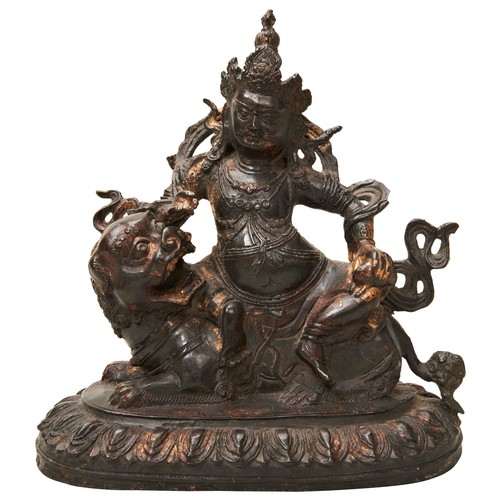 498 - GILT COPPER ALLOY FIGURE OF VAISHRAVANASINO-TIBETAN, 18TH CENTURYthe deity cast in lalitasana atop a... 