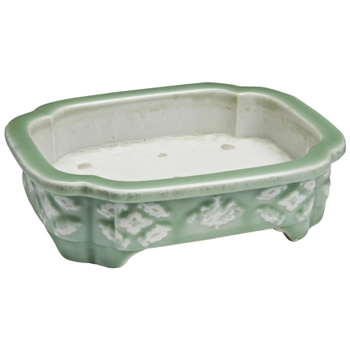 319 - LARGE CELADON-GROUND AND WHITE SLIP JARDINIERELATE QING DYNASTYof rectangular form, the sides decora... 