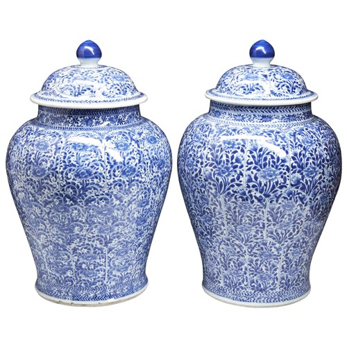 181 - A LARGE PAIR OF BLUE AND WHITE COVERED JARSKANGXI PERIOD (1662-1722)the baluster sides moulded petal... 