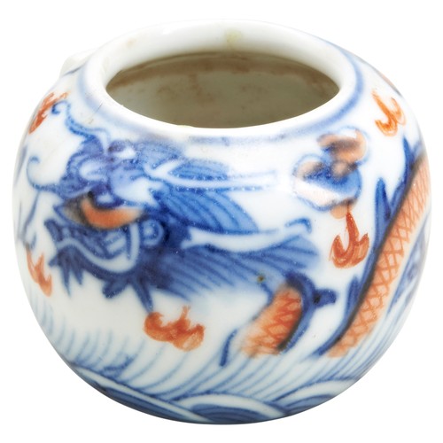 192A - AN UNDERGLAZE BLUE AND IRON-RED BIRD FEEDERQING DYNASTY, 18TH / 19TH CENTURYdecorated with a writhin... 