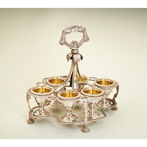 111 - AN ANGLO-INDIAN EGG CRUET WITH SIX EGG CUPS, CALCUTTA C.1830. An egg cruet frame with a cast florate... 