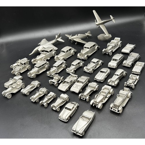 521 - PEWTER MODEL CAR AND AEROPLANE COLLECTION A collection of pewter miniature cars and aeroplanes, most... 