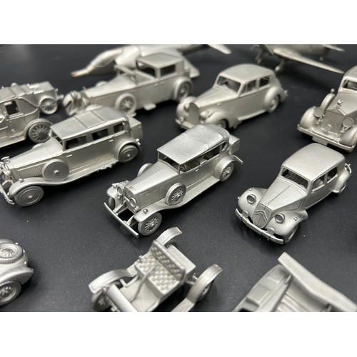 521 - PEWTER MODEL CAR AND AEROPLANE COLLECTION A collection of pewter miniature cars and aeroplanes, most... 