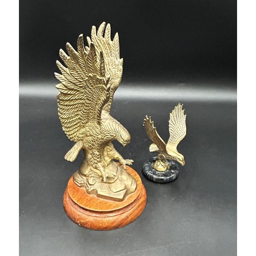 284 - TWO EAGLE CAR MASCOTSA large brass eagle mascot, 22cm tall, on a wooden plinth.Also, a small brass e... 