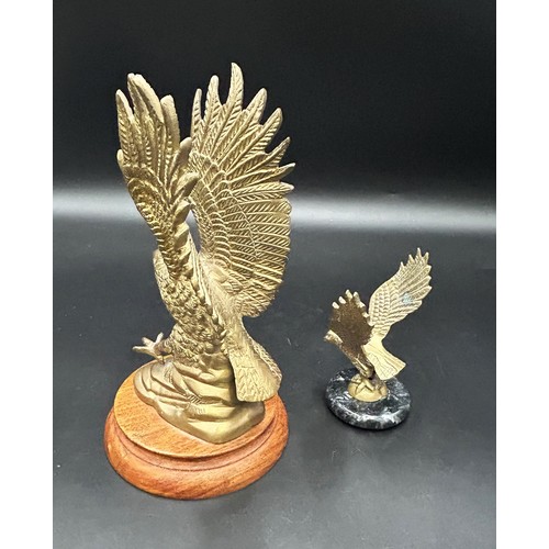 284 - TWO EAGLE CAR MASCOTSA large brass eagle mascot, 22cm tall, on a wooden plinth.Also, a small brass e... 