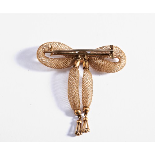 224 - A VICTORIAN GOLD AND HAIR BROOCH, CIRCA 1860the bow with central gold disc and the ribbons with gold... 