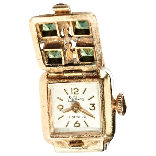 434 - A LADIES RING WATCHsigned silvered dial, the lifting front set with four semi-precious green stones.... 