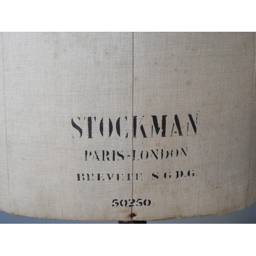 450 - AN EARLY 20TH CENTURY 'STOCKMAN' DRESSMAKER'S MANNEQUIN, the torso with printed manufacturer's mark,... 