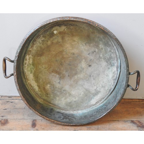 107 - A LARGE 19TH CENTURY COPPER PRESERVING PAN, with twin riveted ring handles (58 cm diam)