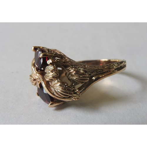 407 - AN UNUSUAL GARNET MOUNTED GOLD RING, the two pear shaped garnets set in a foliate decorated mount, t... 