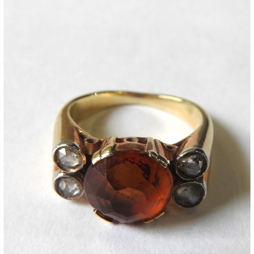 410 - A VINTAGE DIAMOND AND CITRINE SET GOLD RING, the solitaire citrine flanked by four small diamonds, m... 