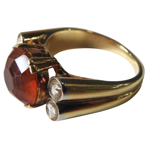 410 - A VINTAGE DIAMOND AND CITRINE SET GOLD RING, the solitaire citrine flanked by four small diamonds, m... 