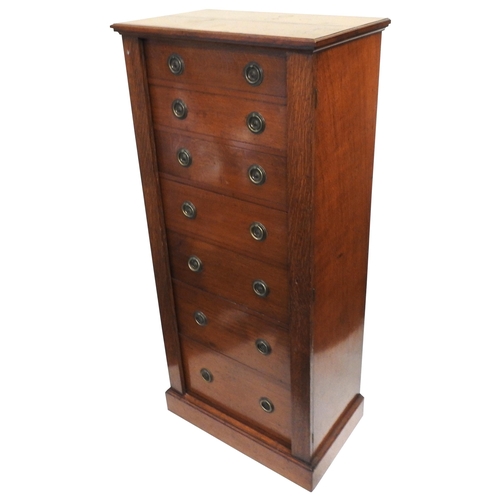 93 - A VICTORIAN OAK WELLINGTON CHEST, comprised of seven graduated drawers with hinged locking stiles, r... 