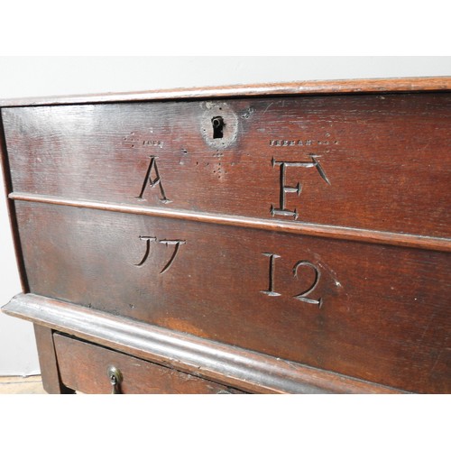 94 - A EARLY 18TH CENTURY OAK COFFER ON STAND, hinged rectangular top above a frieze panel subdivided by ... 