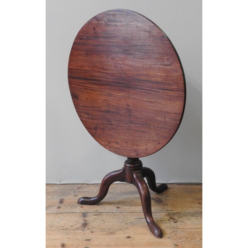 65 - A GEORGE III MAHOGANY TRIPOD TABLE, circular tilting top on a tapering rope twist pillar, raised on ... 