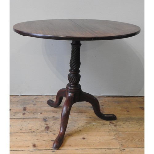 65 - A GEORGE III MAHOGANY TRIPOD TABLE, circular tilting top on a tapering rope twist pillar, raised on ... 