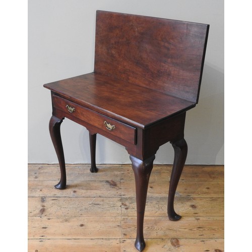 63 - A 19TH CENTURY MAHOGANY TEA TABLE, fold over rectangular top over a single frieze drawer, raised on ... 