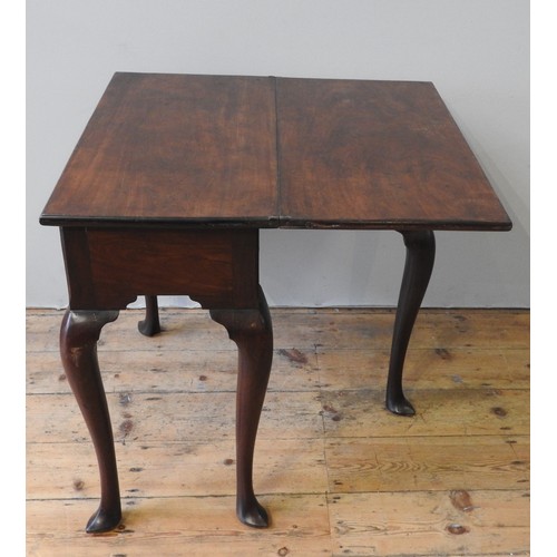 63 - A 19TH CENTURY MAHOGANY TEA TABLE, fold over rectangular top over a single frieze drawer, raised on ... 