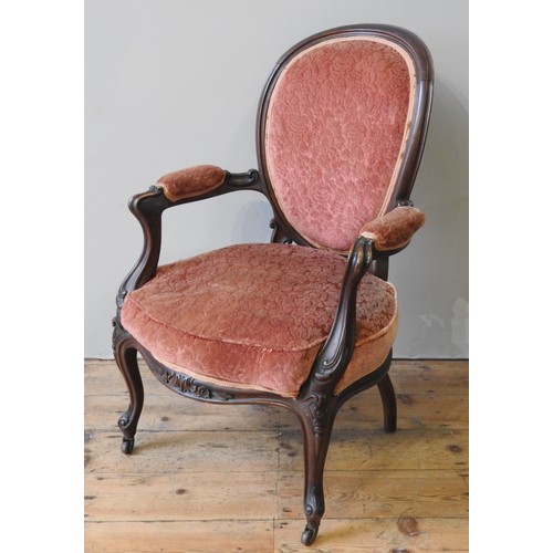 61 - A 19TH CENTURY MAHOGANY FRAMED FAUTEUIL, padded balloon back over a serpentine front seat, flanked b... 