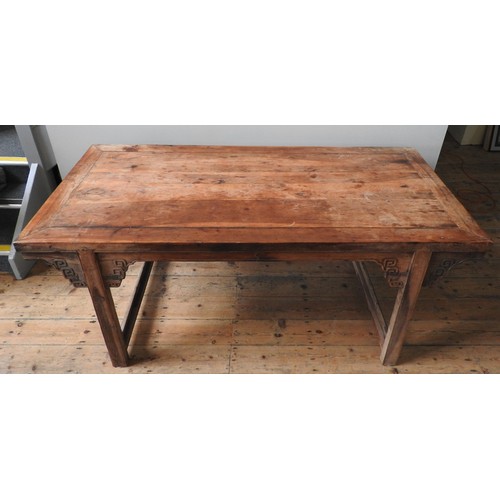 85 - A CHINESE KANG DINING TABLE, rectangular top raised on twin trestle ends, with carved angle brackets... 