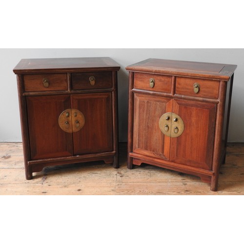 84 - A PAIR OF CHINESE HARDWOOD SIDE CABINETS, tapering form with two short frieze drawers over two panel... 