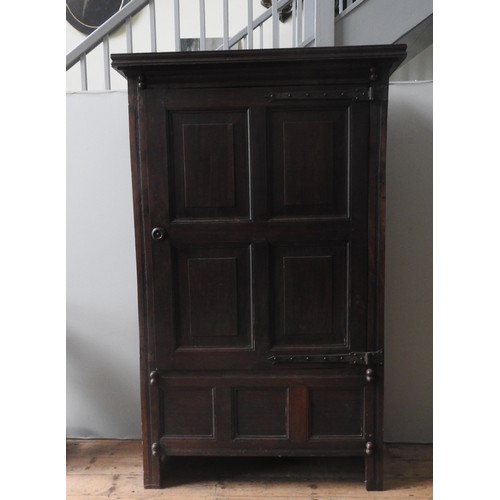 457 - A GEORGE III OAK PANELLED HOUSE CUPBOARD, circa 1780, rustic rectangular form with a panelled door e... 