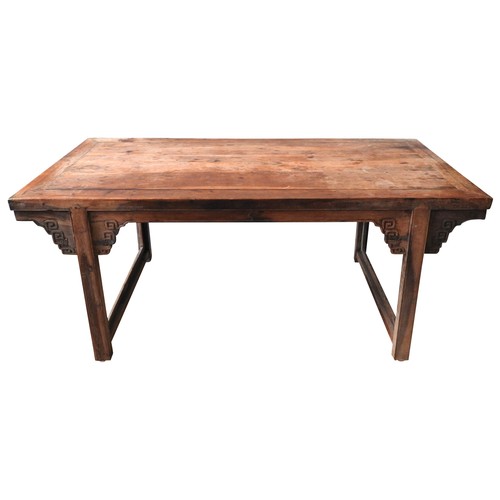 85 - A CHINESE KANG DINING TABLE, rectangular top raised on twin trestle ends, with carved angle brackets... 