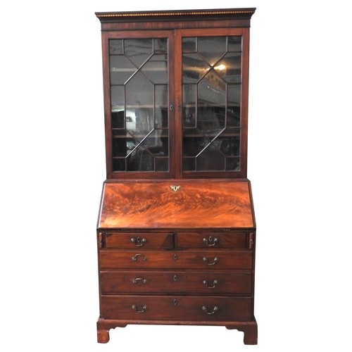 456 - AN EARLY 19TH CENTURY MAHOGANY BUREAU BOOKCASE, the top section comprised of a dentil cornice above ... 