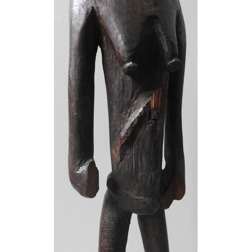 242 - A CARVED PAPUA ASMAT FIGURE AND A CARVED MAKONDE GROUP FIGURE, along with a slender bronze figure68 ... 