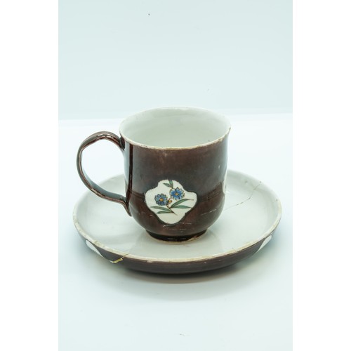 808 - A STAFFORDSHIRE 'BATAVIAN WARE' CUP AND SAUCERCIRCA 1750-60The cup of slight bell shape glazed brown... 