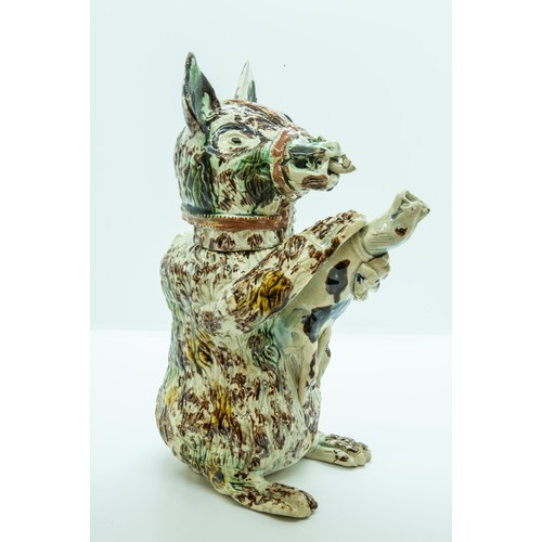 825 - A PEARLWARE BEAR JUGCIRCA 1800Decorated in Pratt type colours, the muzzled bear holding a hound. 23.... 