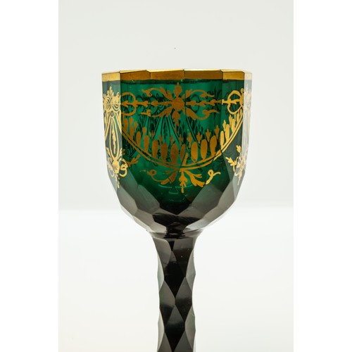 1208 - A GREEN GLASS WITH GILDED DECORATION18TH CENTURYDecorated with gilded sways, raised on a faceted ste... 