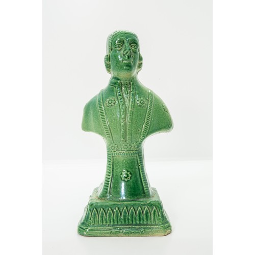 849 - A GREEN GLAZED POTTERY BUSTLATE 18TH CENTURYDepicting a bewigged gentleman, raised on a socle, 18.5c... 
