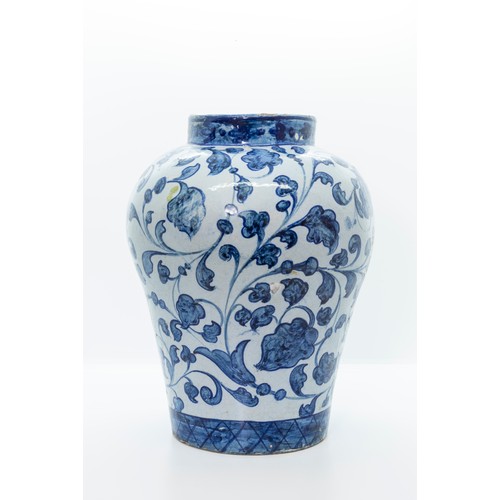 880 - A FAIENCE DRUG JAR18TH CENTURYWith inscribed scroll on a leaf scroll ground, 27cms high