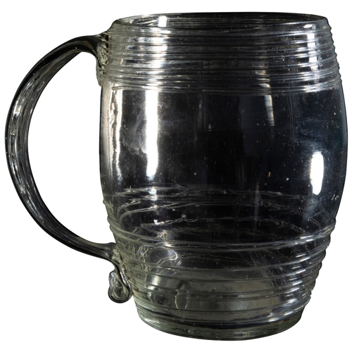 1219 - AN 18TH CENTURY TANKARDCIRCA 1750Of barrel form with slip trailed decoration, together with an engra... 