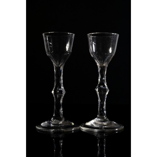 1220 - A PAIR OF FACETTED STEMMED WINE GLASSESMID 18TH CENTURY14.5cms high