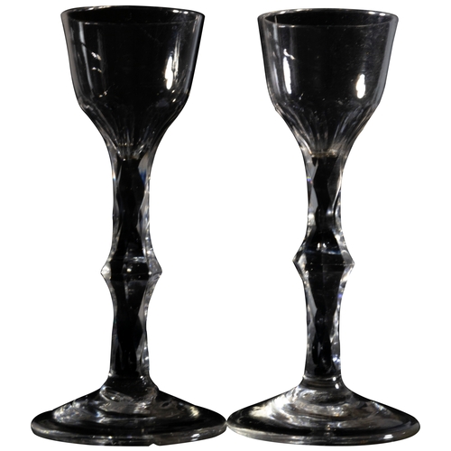 1220 - A PAIR OF FACETTED STEMMED WINE GLASSESMID 18TH CENTURY14.5cms high