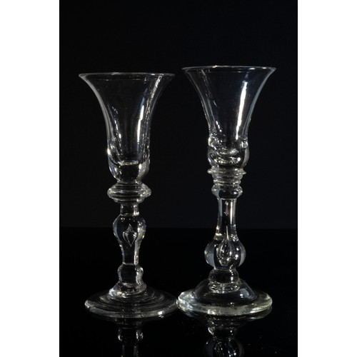 1221 - TWO SIMILAR WINE GLASSESMID 18TH  CENTURYThe bell shaped bowls raised on knopped stems, tallest is 1... 