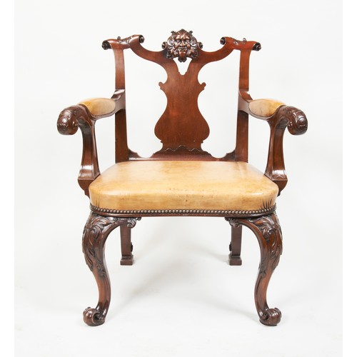 1580 - A GEORGE II STYLE CARVED MAHOGANY AND LEATHER OPEN ARMCHAIRLATE 19TH CENTURYcovered in studded tan l... 