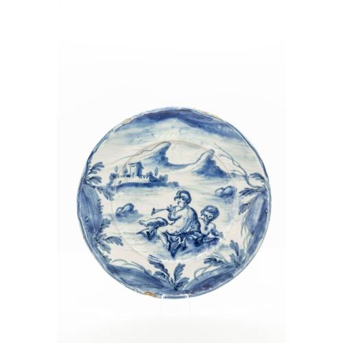 938 - A SAVONA FAIENCE CHARGERCIRCA 1700Typically decorated with cherubs in a landscape, 23cms