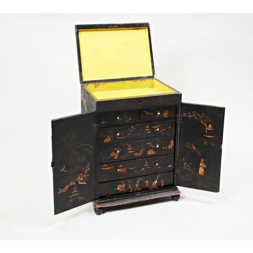 1673 - A BLACK JAPANNED COLLECTORS CABINETMID 19TH CENTURY with chinoiserie decoration throughout, the two ... 