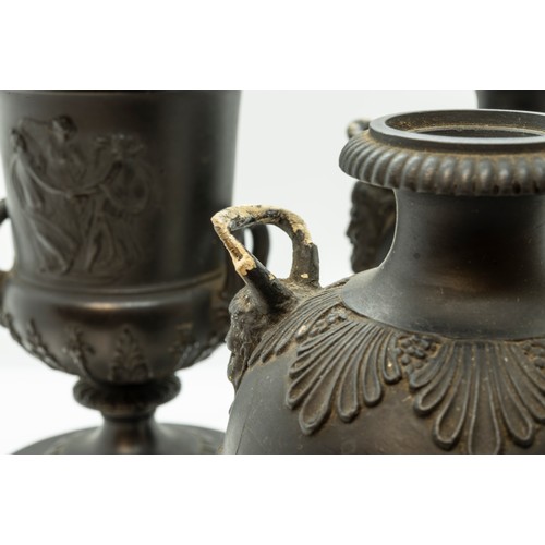 965 - A WEDGWOOD BLACK BASALT CAMPAGNA URN18TH CENTURYTogether with a pair of urns, 17cms high