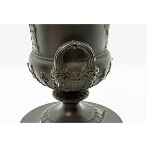 965 - A WEDGWOOD BLACK BASALT CAMPAGNA URN18TH CENTURYTogether with a pair of urns, 17cms high