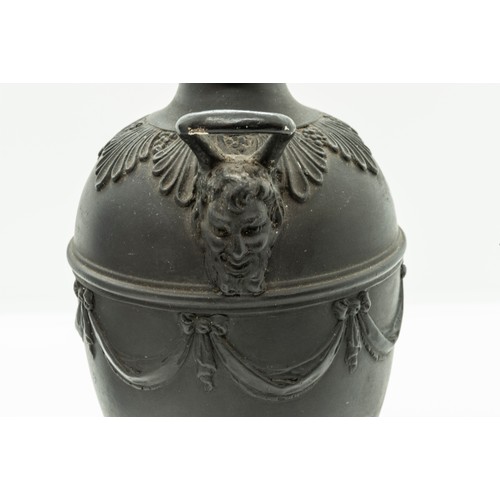 965 - A WEDGWOOD BLACK BASALT CAMPAGNA URN18TH CENTURYTogether with a pair of urns, 17cms high