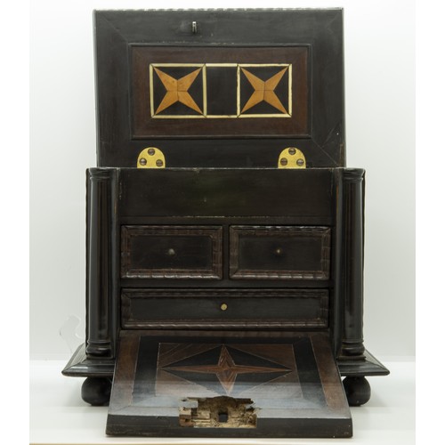 1898 - A FLEMMISH EBONY AND PARQUETRY CASKET18TH CENTURYwith a hinged top and fall front enclosing three fi... 