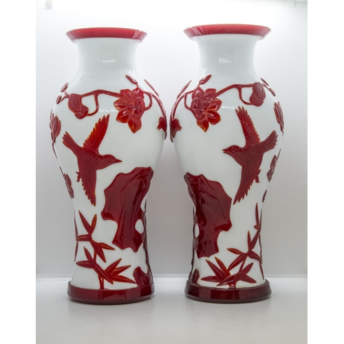 2151 - A PAIR OF CHINESE RED-OVERLAY ON WHITE GLASS VASESLATE QING / REPUBLIC PERIOD of baluster form35cm h... 