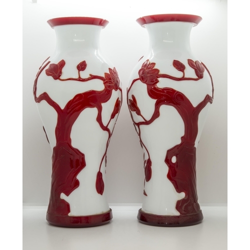 2151 - A PAIR OF CHINESE RED-OVERLAY ON WHITE GLASS VASESLATE QING / REPUBLIC PERIOD of baluster form35cm h... 